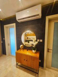 a bathroom with a vanity and a mirror on a wall at Country View Retreat in Żabbar