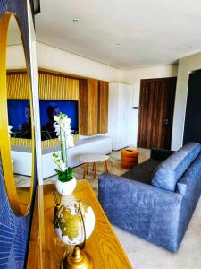a living room with a blue couch and a table at Country View Retreat in Żabbar