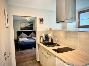 a kitchen with a sink and a couch in a room at Fewo Am Brunnen in Rüdesheim am Rhein