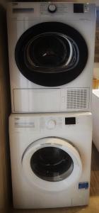 two dryers are stacked on top of each other at Country View Retreat in Żabbar