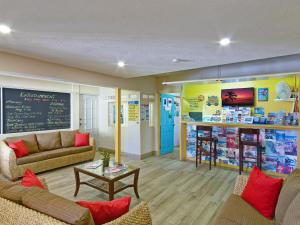 a room with two couches and a table in a store at Coconut Court Beach Hotel in Bridgetown