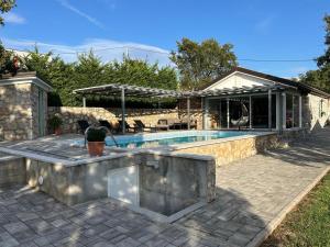 a swimming pool in a backyard with a house at Villa Jelly in Šmrika