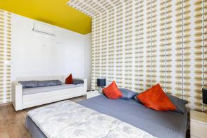 a bedroom with two beds with orange pillows at Agritur Michelotti Giancarlo in Arco +91 photos