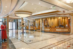 a woman standing in a lobby of a building at Crowne Plaza Bahrain by IHG in Manama +37 photos