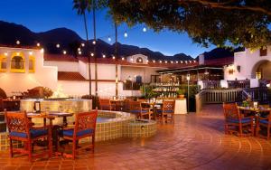 a restaurant with tables and chairs and a fountain at Legacy Villas private 3 bedroom 3 bath villa with view, steps to pool, bikes and arcade game included in La Quinta