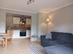 a living room with a couch and a kitchen at Ferienwohnung Bauer Katrin und Florian in Prien am Chiemsee