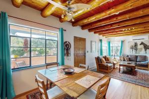 a living room with a wooden table and a couch at Casa Mirador in Santa Fe