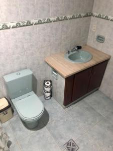 a bathroom with a toilet and a sink at Chez AriCo, Cochabamba in Calacala