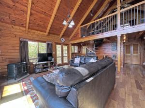 a large living room with a large leather couch at High Haven in Bryson City