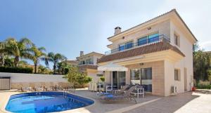 a house with a swimming pool in front of it at Sonja in Paralimni
