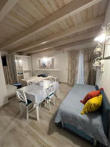 un soggiorno con un tavolo e una camera da letto di Camere Marisol a Porto Cesareo