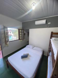 a small room with a bed and two bunk beds at Doce Lar Hospedaria in Lençóis