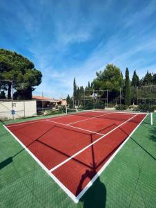 a tennis court with a red and white at Villa Marovi Bonalba in Alicante