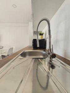 a kitchen sink with a faucet on a counter at Tomasoni summer house in Armação de Pêra +52 photos