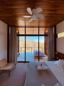 a bedroom with a bed and a ceiling fan at Villa Gaspar Terrazas in Playa hermosa +63 photos