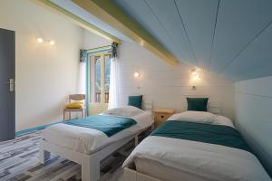 a room with two twin beds in a house at Chalet les 4 saisons - Ski, parking et jardin in La Chapelle-dʼAbondance