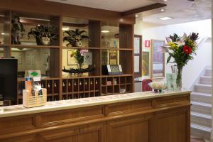 a counter in a store with flowers on it at Hotel Commercio & Pellegrino in Venice