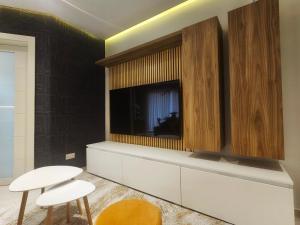a living room with a large tv on a wall at Country View Retreat in Żabbar