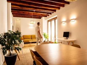 a man walking through a living room with a table at Laguna Cool Living in Las Lagunas