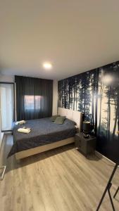 a bedroom with a bed and a tv in it at Casa di Grazia Bijeljina in Bijeljina
