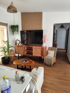 a living room with a large flat screen tv at casa de vacaciones playa cerca in Palo Verde
