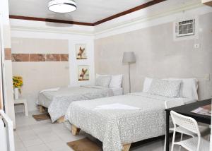 a room with two beds and a couch in it at Hotel Mango in Boca Chica +21 photos