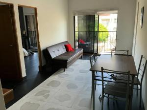 a living room with a couch and a table at Aparta Suites Torre de Prado 501 Apartamento para 7 Personas in Medellín