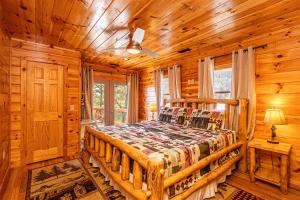 a bedroom with a bed in a log cabin at A Treehouse View Over Lake in Roundhill +37 photos