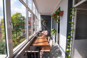 a balcony with a wooden table and chairs and windows at Alpacino Apart Hotel in Istanbul