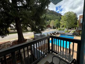a balcony with a view of a swimming pool at Shadow Mountain Lodge in Aspen