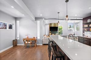 a kitchen with a white counter top and a living room at Minutes to Ski Resorts & Downtown, Yard, Fire Pit in Millcreek