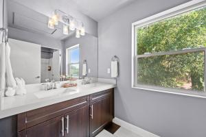 a bathroom with two sinks and a window at Minutes to Ski Resorts & Downtown, Yard, Fire Pit in Millcreek +28 photos