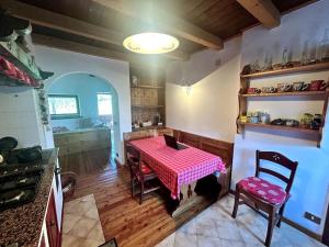 a kitchen with a table with a red and white table cloth at La Mansarda di Laura a Danta in Danta