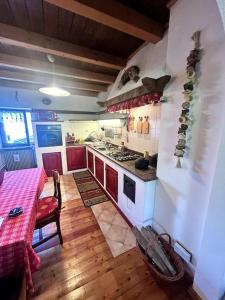 a kitchen with a table and a stove top oven at La Mansarda di Laura a Danta in Danta +45 photos