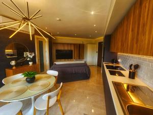 a kitchen and living room with a table and a bed at Country View Retreat in Żabbar