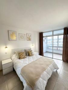 En eller flere senge i et værelse på Apartamento Playa Cañon del águila + 10 billeder
