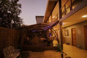 a house with an outdoor patio with a purple lighting at Pousada Egrégora in Sao Jorge