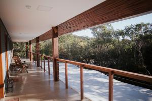 a balcony of a house with a view of trees at Pousada Egrégora in Sao Jorge