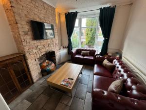 a living room with a couch and a coffee table at Bolsover Castle View in Bolsover