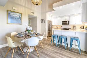 a kitchen and dining room with a table and chairs at Stunning 2nd Floor Beachfront Home with Balcony, Ocean Views, and Prime Location in Newport Beach