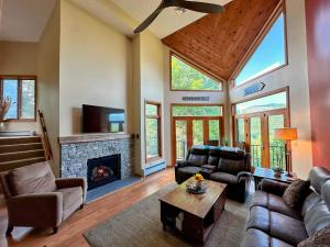 a living room with a couch and a fireplace at C13 Beautiful Bretton Woods ski-in ski-out townhouse for your family getaway to the White Mountains! in Bretton Woods