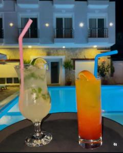two drinks sitting on a table next to a pool at Hotel Adriatik Orikum in Orikum +55 photos