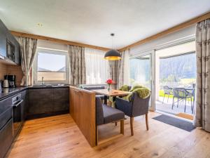 a kitchen with a table and a dining room with a view at Chalet Pettneu am Arlberg - Top 2 in Pettneu am Arlberg