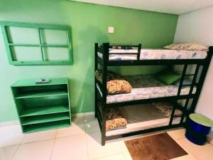 En eller flere senge i et værelse på Pousada Ideal - Estúdios com Cozinha & Terraço Exclusivo - Suítes Econômicas