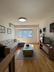 a living room with a couch and a table at Cozy apartment-center of Skopje in Skopje