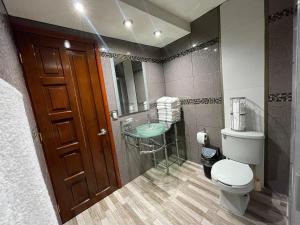 a bathroom with a toilet and a sink at Residencia en Chignahuapan in Chignahuapan +26 photos