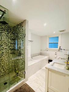 a bathroom with a shower and a sink and a tub at Meet友缘 in Vancouver +34 photos