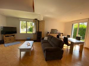 a living room with a couch and a tv at Holiday Home in Damgan near Sandy Beaches in Damgan