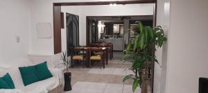 a living room with a couch and a dining room at Hotel Kapac in Mendoza
