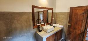 a bathroom with a sink and a mirror at Undiya The Neighborhood Sigiriya in Sigiriya